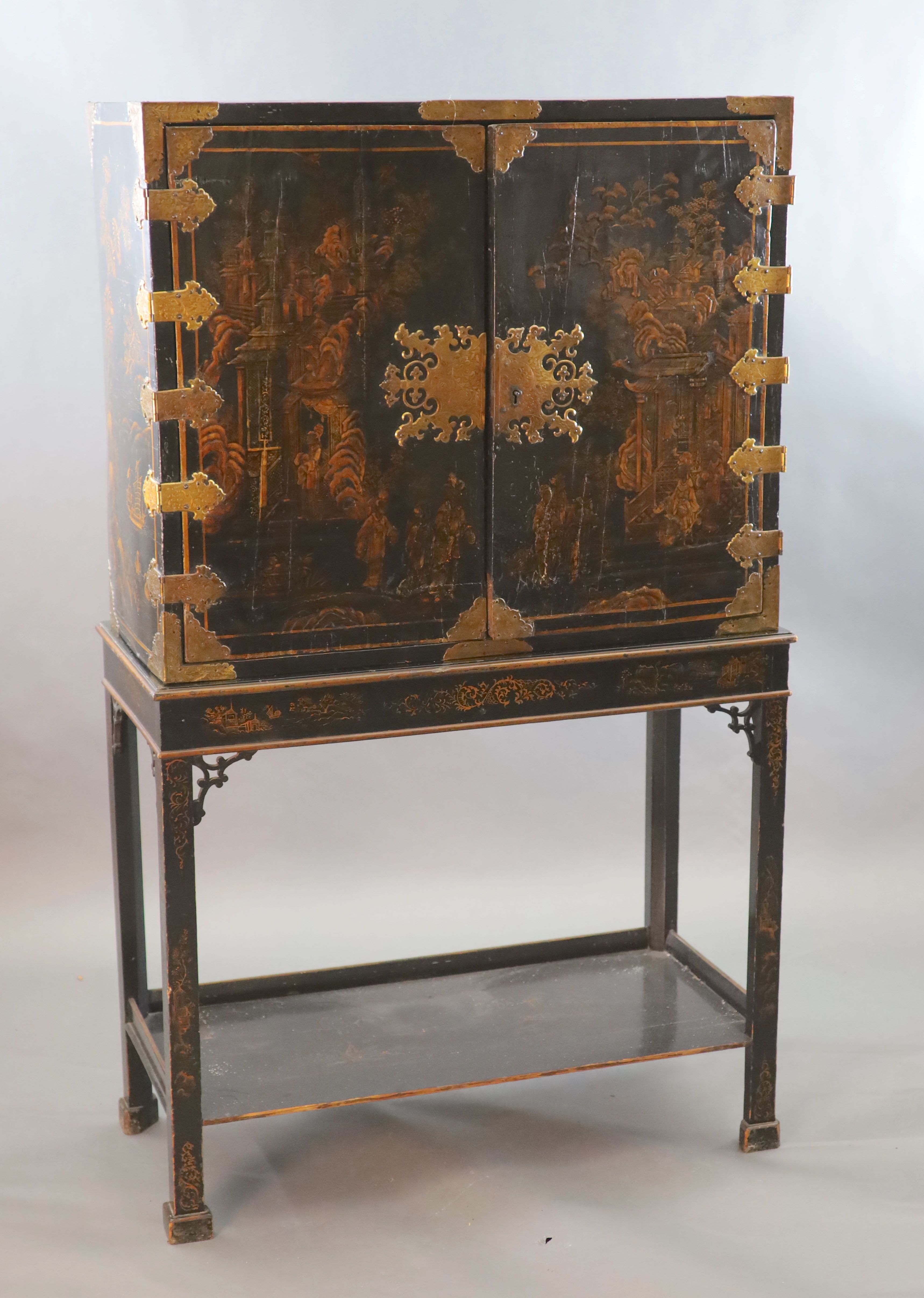A late 17th century japanned cabinet on later stand W. 3ft. 1in. D. 1ft 4.5in. H. 2ft. 6in. Height overall 6ft 3in.